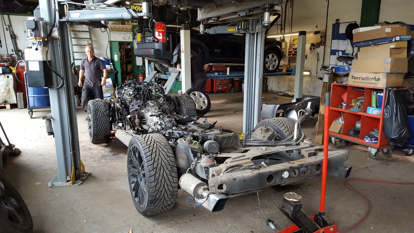 A Range Rover stripped to its chassis on a lift in the Chichester 4x4 workshop